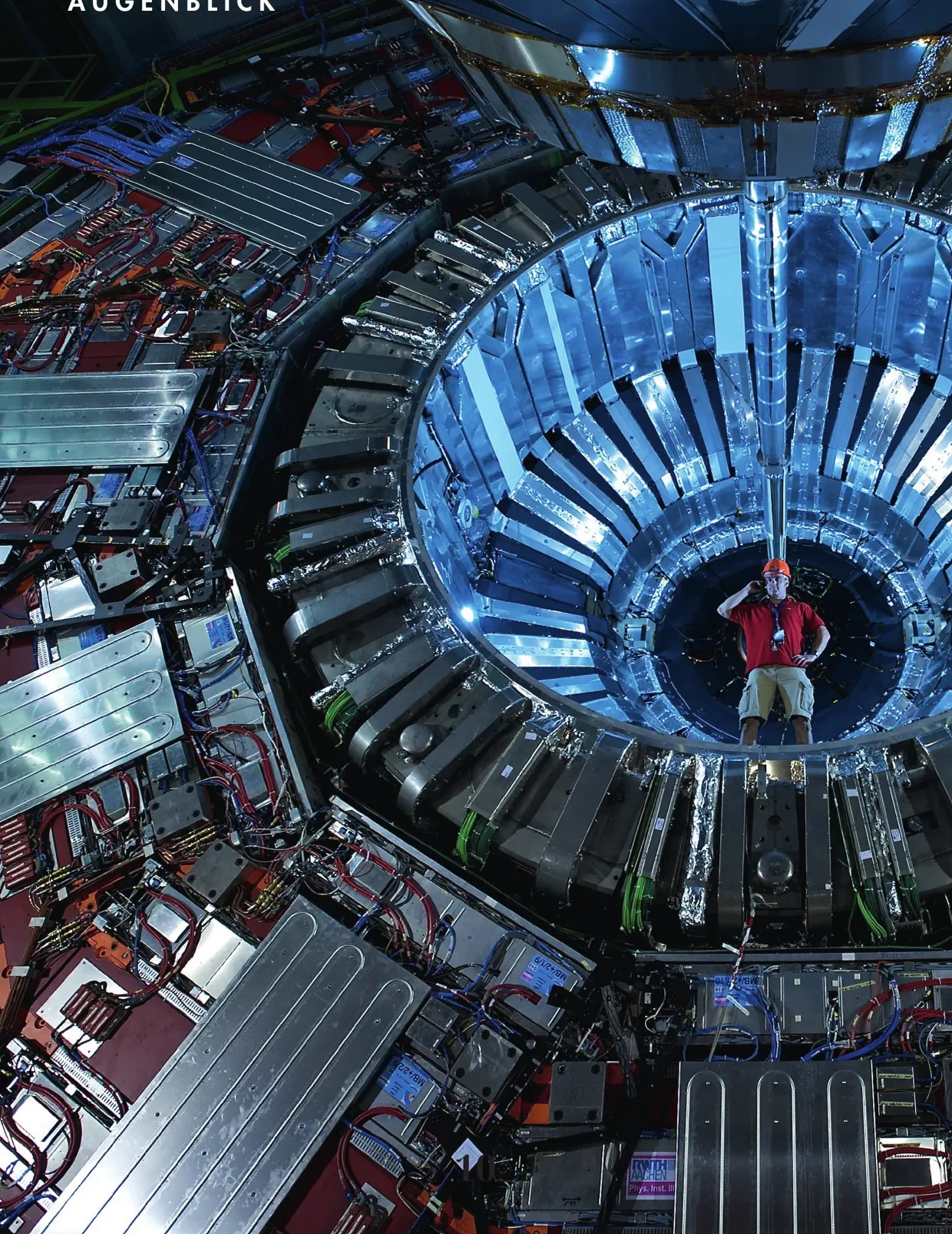 A person in the CMS detector conveys the scale of the CERN particle accelerator near Geneva.