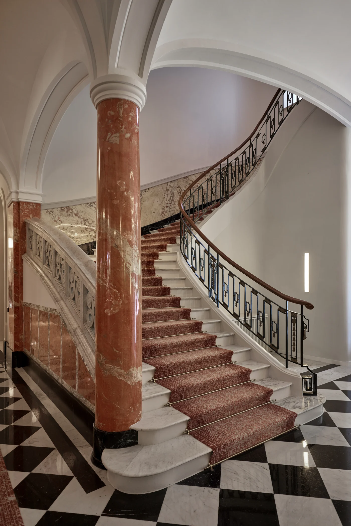 Heritage-listed elegance: the Palace’s sweeping staircase with marble columns and a chequerboard floor. Photo: Mandarin Oriental