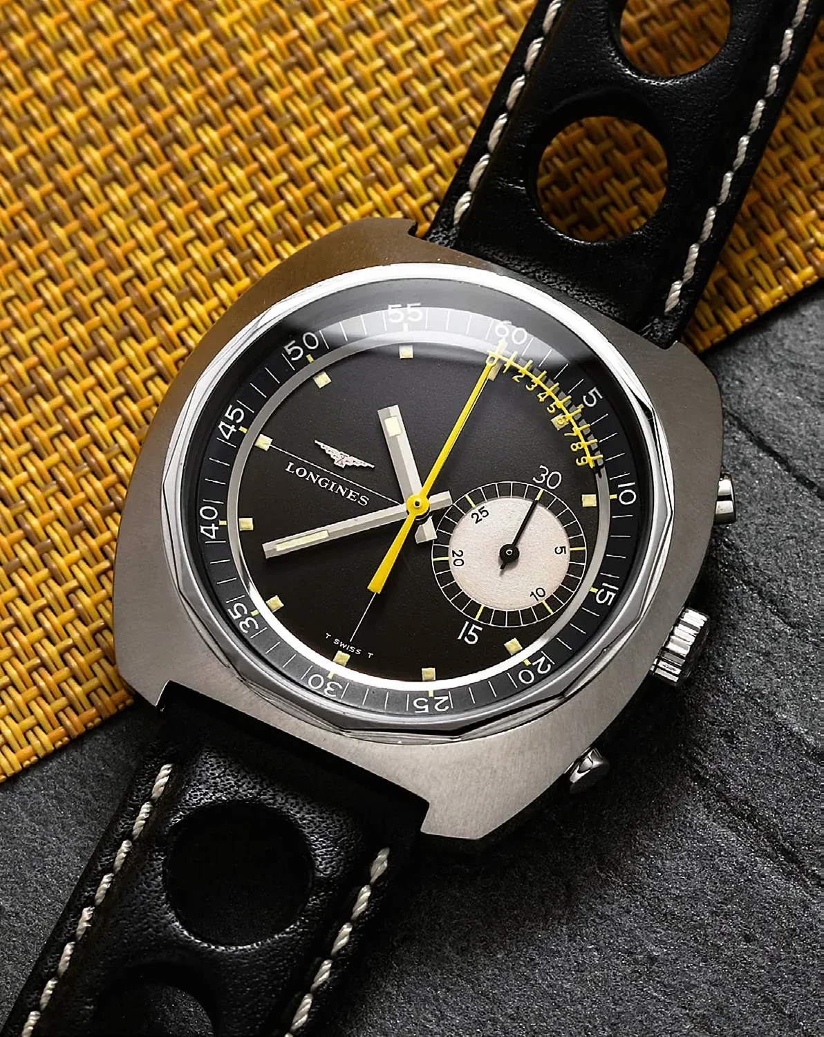 Longines Nonius, ref. 8225-2, circa 1969, with a tonneau-shaped stainless-steel case, two pushers for the chronograph – the upper one for start/stop, the lower one for resetting to zero – plus a sporty leather strap with pin buckle (neither of them Longines); hand-wound; black dial with small square indices coated with luminous material. Size: 42×44 millimetres.